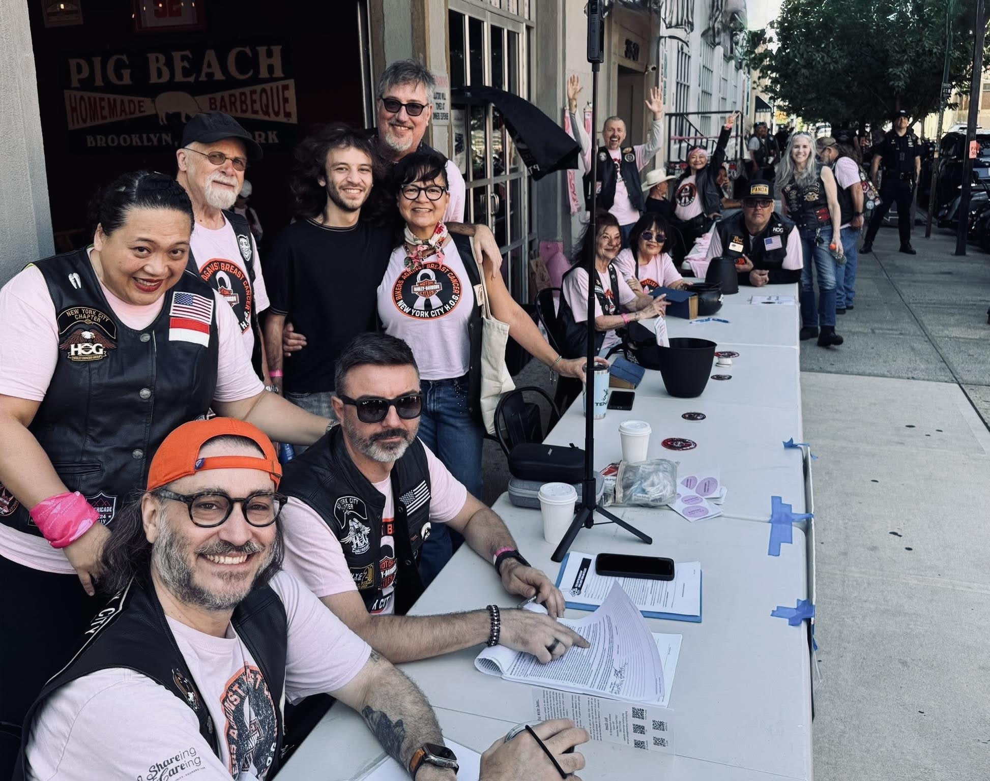 Motorcycle riders at a registration table